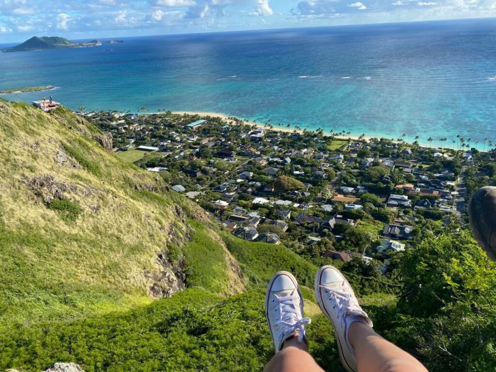 Arielle's white converse shoes at the top of a hike on Oahu island